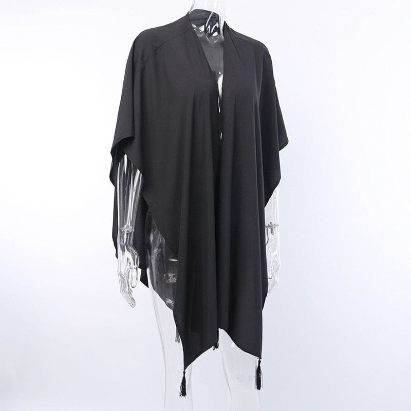 Black shawl on a clear mannequin, showing the open front and hanging tassel points.