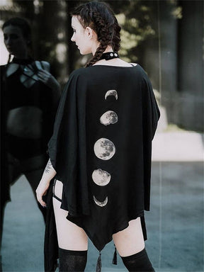 Back view of a black moon phase shawl worn outdoors with dark thigh-high socks.