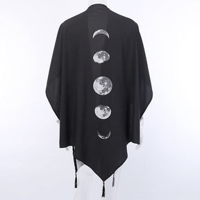 Black moon phase wrap from behind with a pointed lower hem and dangling tassels.