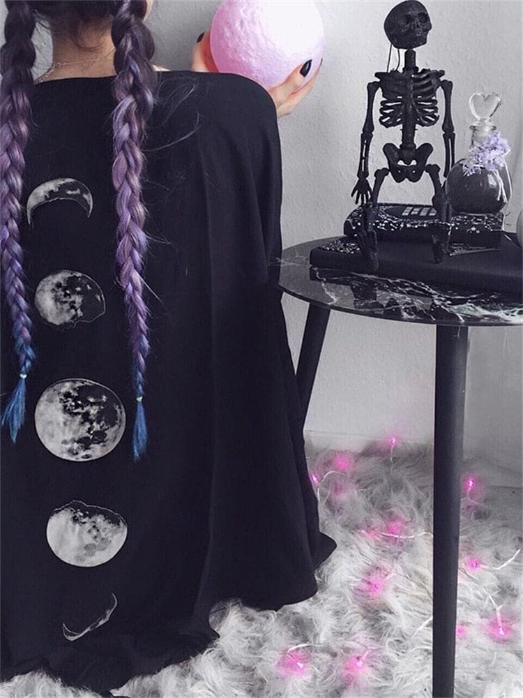 Black moon phase shawl shown from the back with purple braids and celestial room styling.