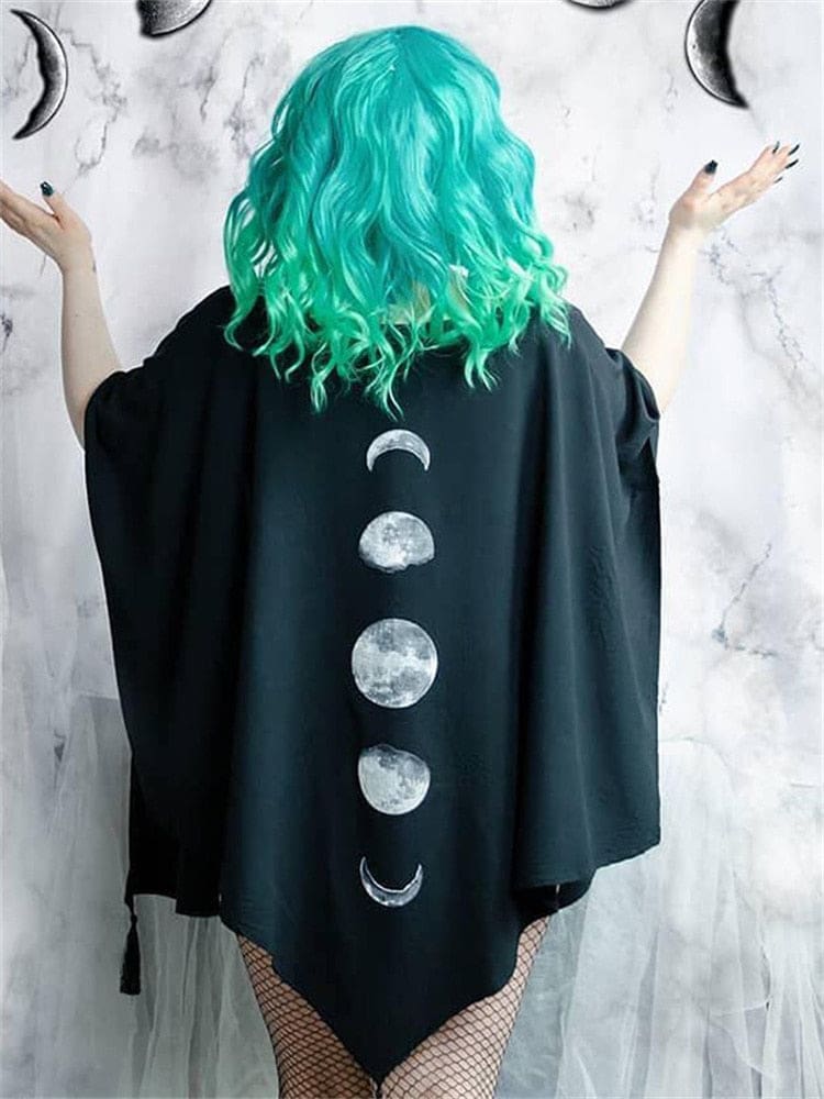 Black lunar wrap worn with arms raised, showing the broad drape and five moon phases.