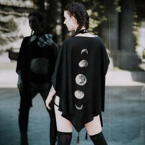 Rear view of the flowing black wrap showing the vertical moon print and uneven pointed hem.