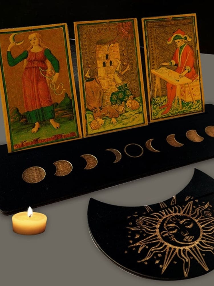 Black rectangle and moon-shaped card holders with pale moon phase artwork, arranged with upright tarot cards.