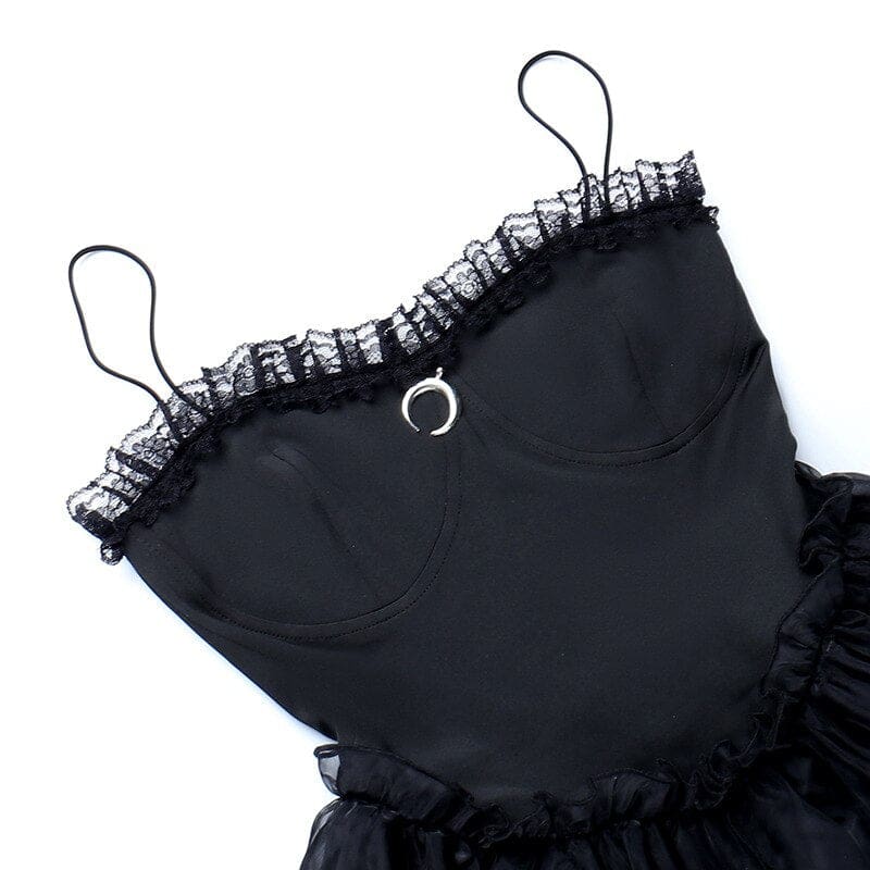 Black dress bodice laid flat, showing curved seams, lace trim and the small crescent detail.