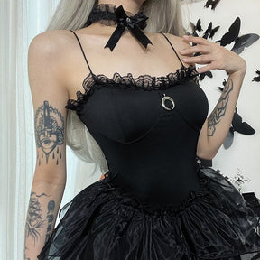 Square close view of the black lace neckline, curved bust seams and silver-tone crescent.