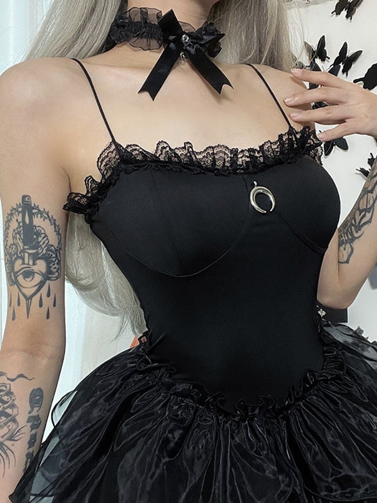 Close-up of the dress neckline with black lace, curved bust seams and a silver-tone crescent charm.