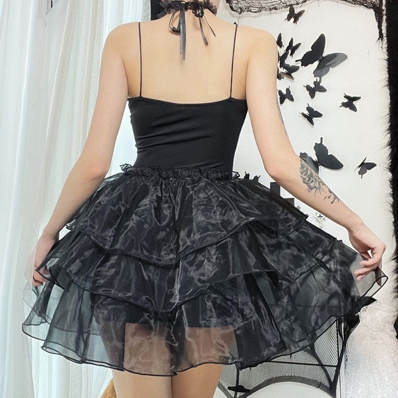 Square back outfit view of the black thin-strap dress and tiered skirt.