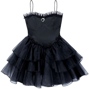 Full flat-lay view of the black moon-charm mini dress with thin straps and tiered skirt.