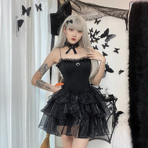 Full outfit view of the black Moon Princess mini dress with dark accessories and a tiered ruffle skirt.