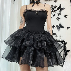 Square front outfit view of the black lace-trim dress, showing the crescent charm above the full ruffle skirt.