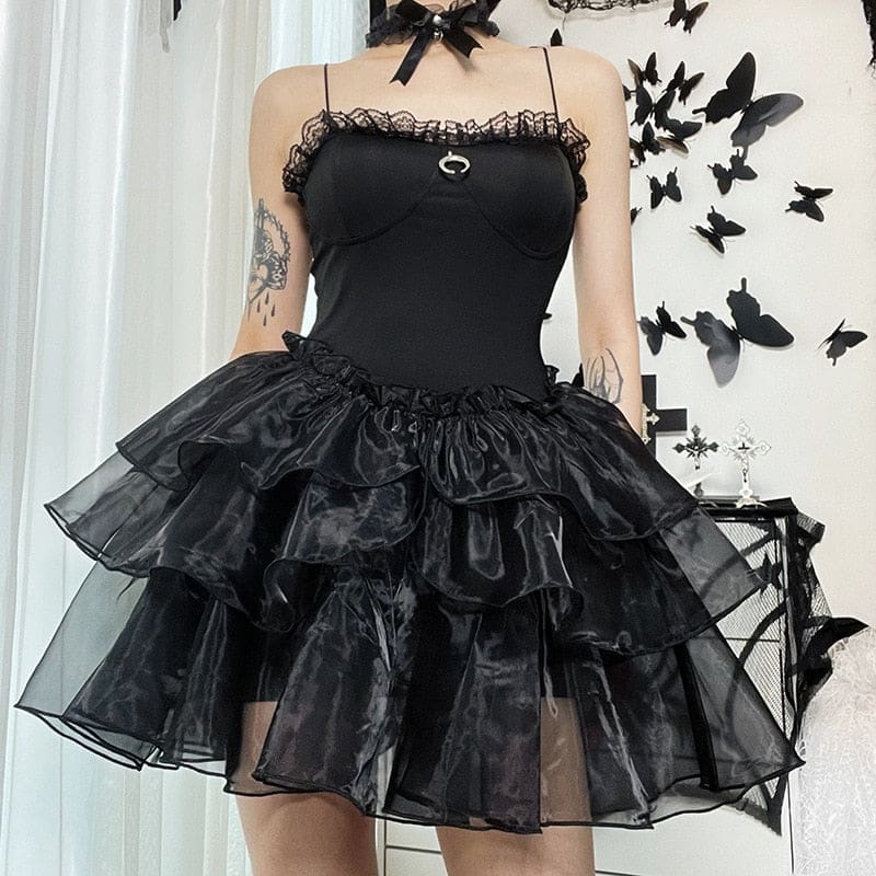 Square front outfit view of the black lace-trim dress, showing the crescent charm above the full ruffle skirt.
