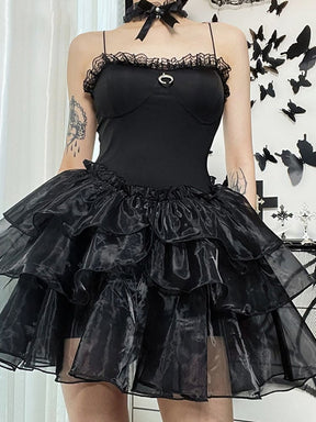 Black mini dress with thin straps, a lace-trimmed bodice and a small silver-tone crescent above a tiered ruffle skirt.