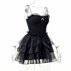 Three-quarter mannequin view of the black dress showing the fitted waist and flared layers of ruffles.