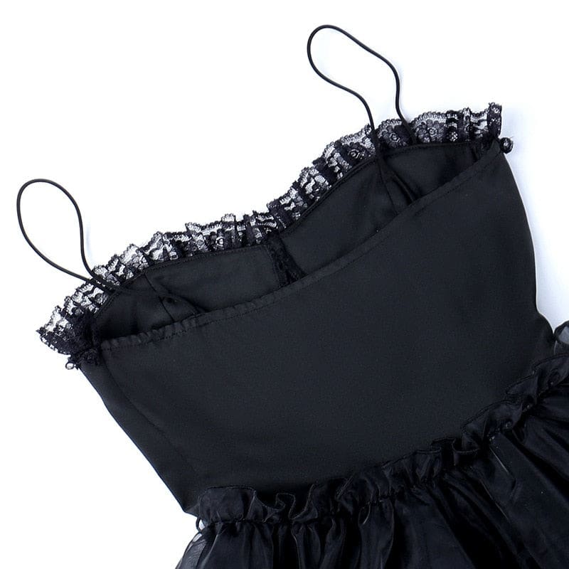 The reverse of the black dress bodice laid flat, showing its seams and smooth fabric.