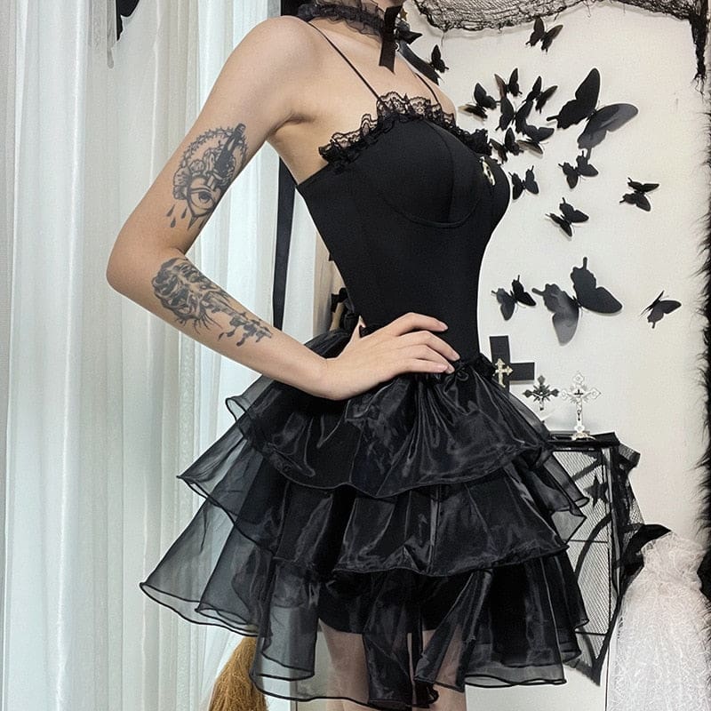 Square side outfit view of the black dress showing the layered ruffles below the fitted waist.