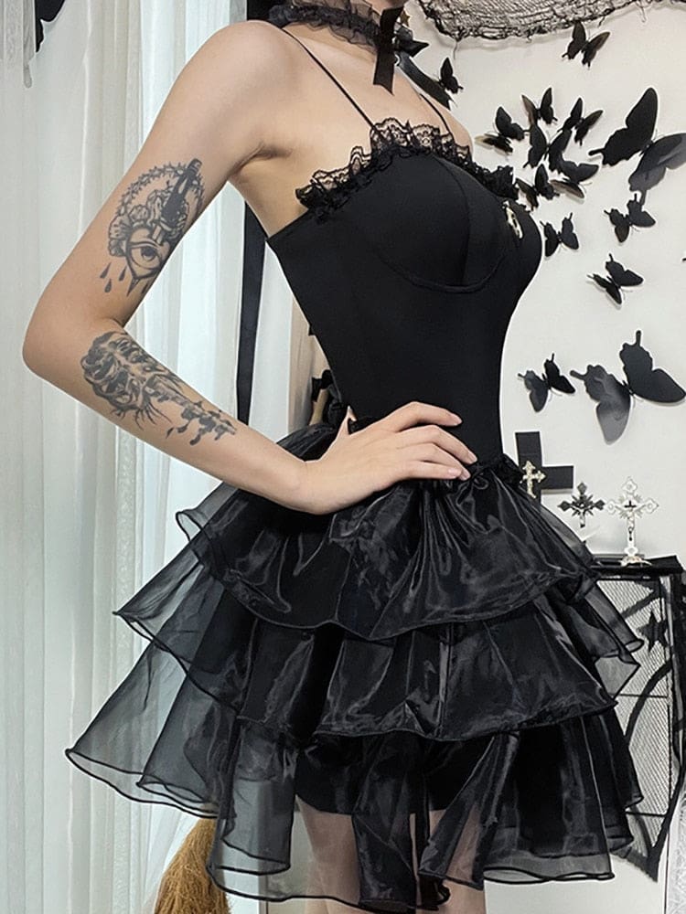 Side view of the black fitted-bodice dress showing the volume of its tiered sheer skirt.