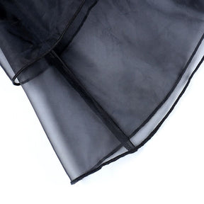 Close-up of the sheer black organza hem and its fine finished edge.