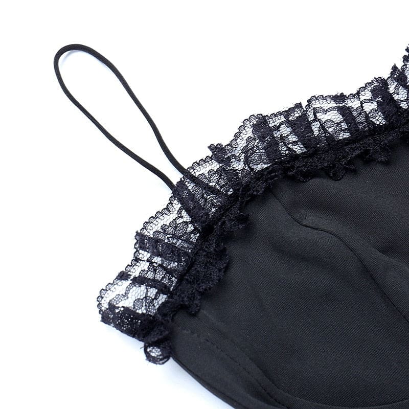 Close-up of a thin black shoulder strap beside the lace-trimmed neckline.