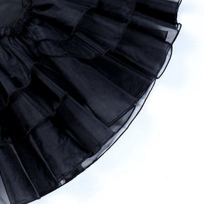 Close view of the black dress skirt’s overlapping sheer organza ruffles.