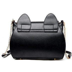 Rear view of the black moon purse, showing the stitched cat-ear tabs, smooth back panel and gold-tone strap attachments.