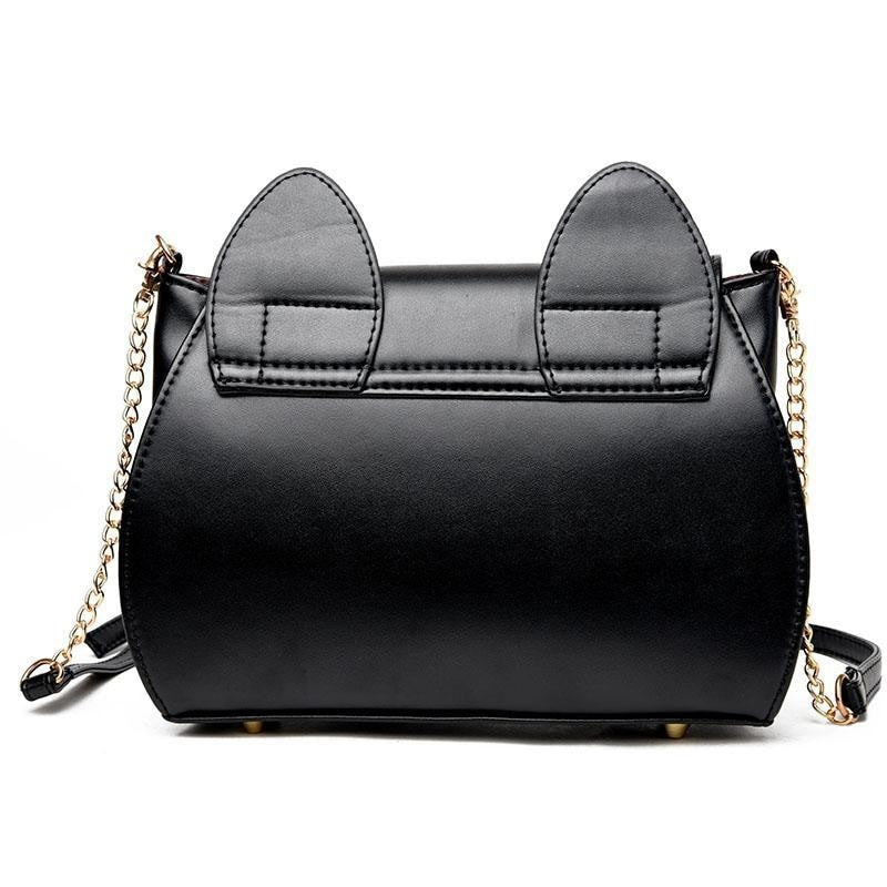 Rear view of the black moon purse, showing the stitched cat-ear tabs, smooth back panel and gold-tone strap attachments.