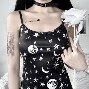 Black moon and star print mini dress with a close worn view of the neckline and celestial print.