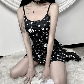 Black moon and star print mini dress shown in a seated outfit.