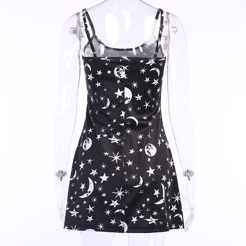Black moon and star print mini dress displayed from the front on a clear mannequin.