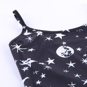 Black moon and star print mini dress with a close view of a strap and the neckline.