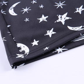 Black moon and star print mini dress with a close view of the printed lower hem.