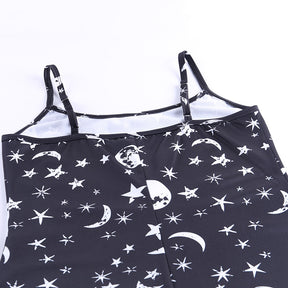 Black moon and star print mini dress showing the back strap sliders and printed upper section.