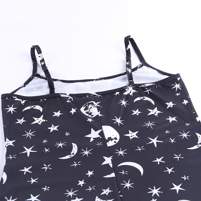 Black moon and star print mini dress showing the back strap sliders and printed upper section.