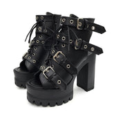 Pair of black open-toe platform booties with four eyelet buckle straps, lace-up fronts and separate high block heels.