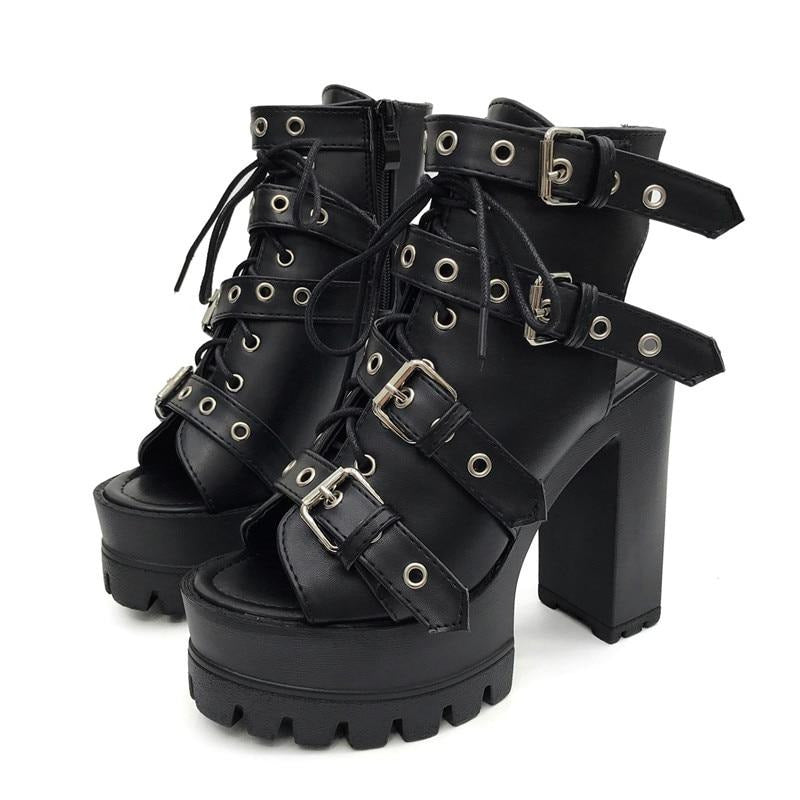 Pair of black open-toe platform booties with four eyelet buckle straps, lace-up fronts and separate high block heels.