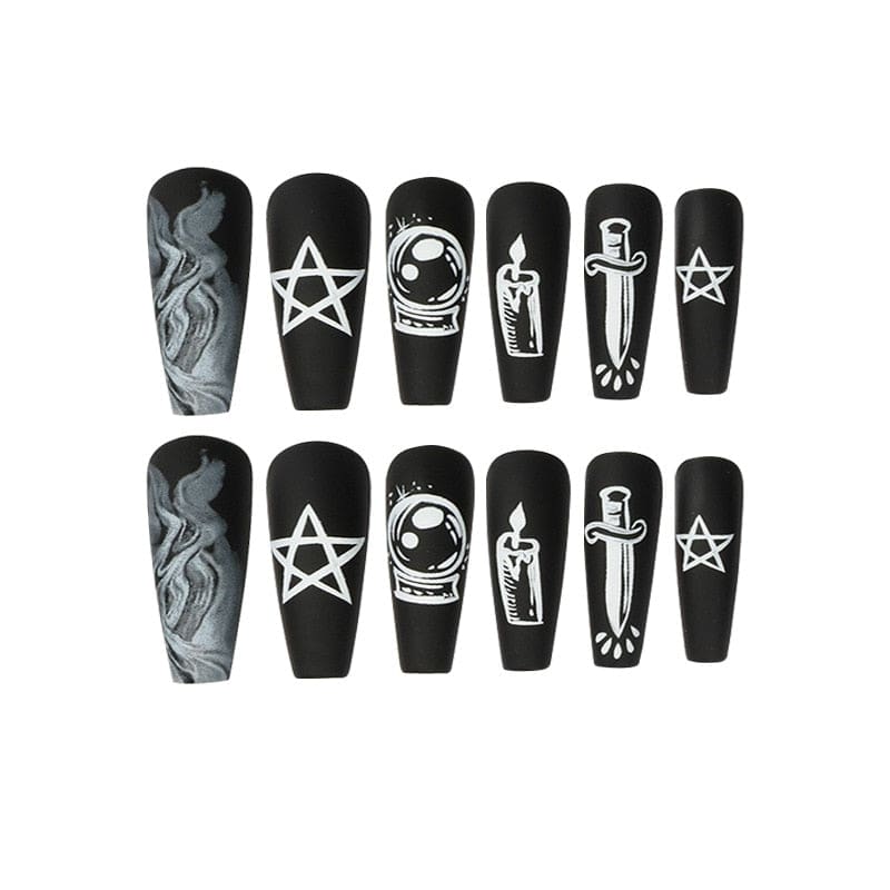 Black coffin-shaped press-on nails arranged on white, with pale pentagrams, a candle, crystal ball, crescent, snake and dagger among smoky decorative details.