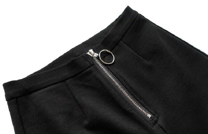 Close-up of the black pants waistband and silver-tone front zipper with a large circular pull.