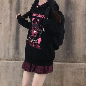 Standing front view of the black and pink hoodie, with long sleeves, dropped shoulders and braided hair.