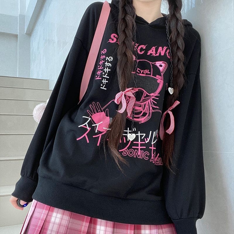 Black pullover hoodie with pink helmet artwork and white heart outlines, styled with pink hair bows.