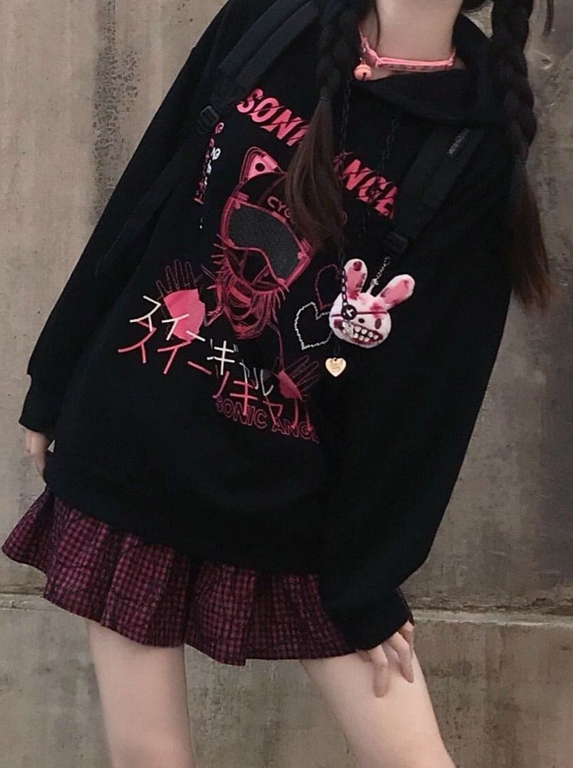 Angled view of the black graphic hoodie, with long sleeves and a pink plaid skirt showing below the hem.
