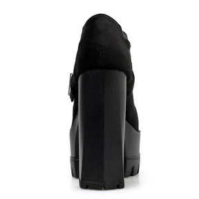 Rear view of a black ankle bootie showing the tall rectangular block heel, covered back and dark upper.