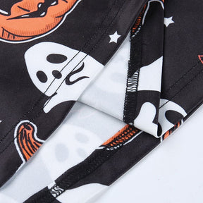 Close-up of the inside seam and stitching on the black pumpkin-and-ghost dress, with the printed surface folded back.