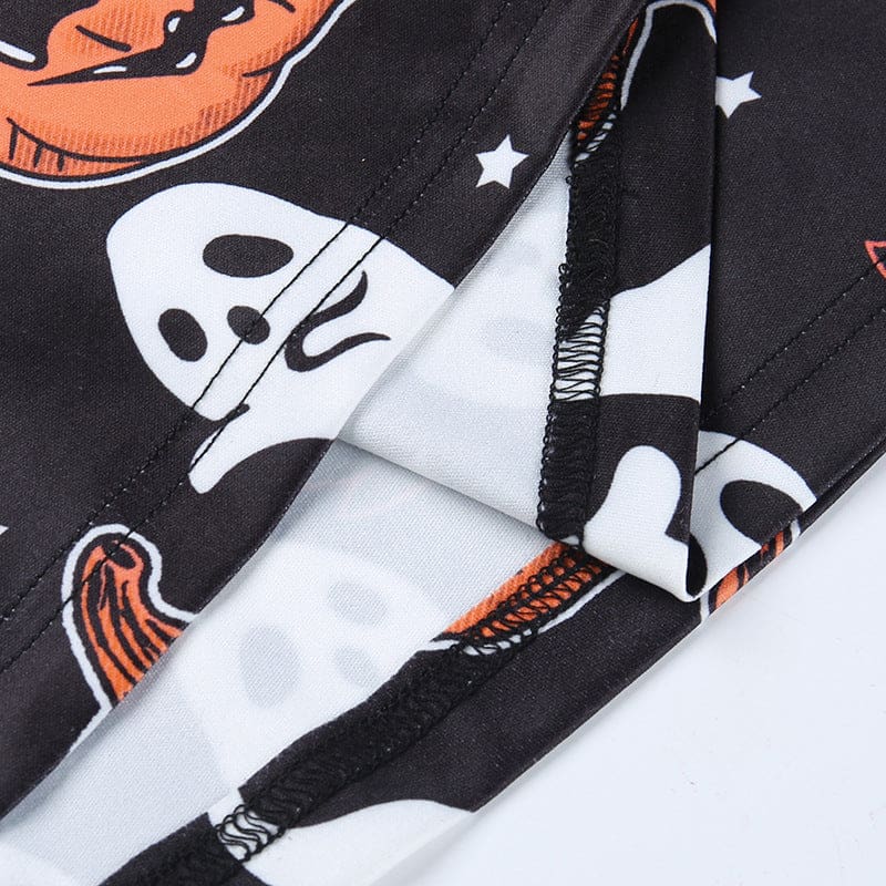 Close-up of the inside seam and stitching on the black pumpkin-and-ghost dress, with the printed surface folded back.