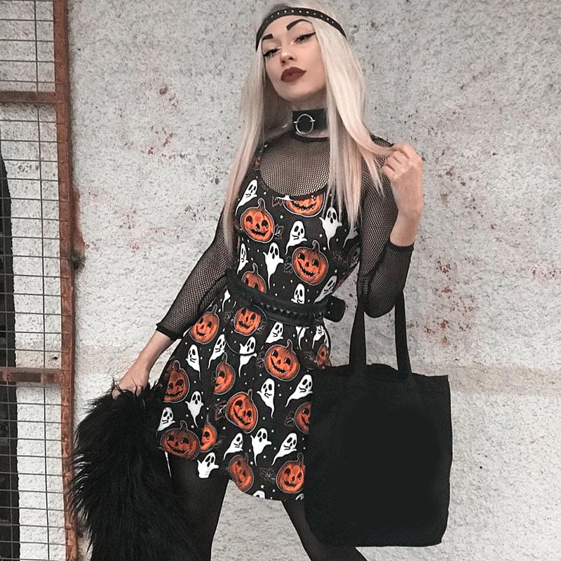 Full outfit view of a blonde-haired model wearing the black Halloween mini dress with dark layers and accessories in front of a grey wall.