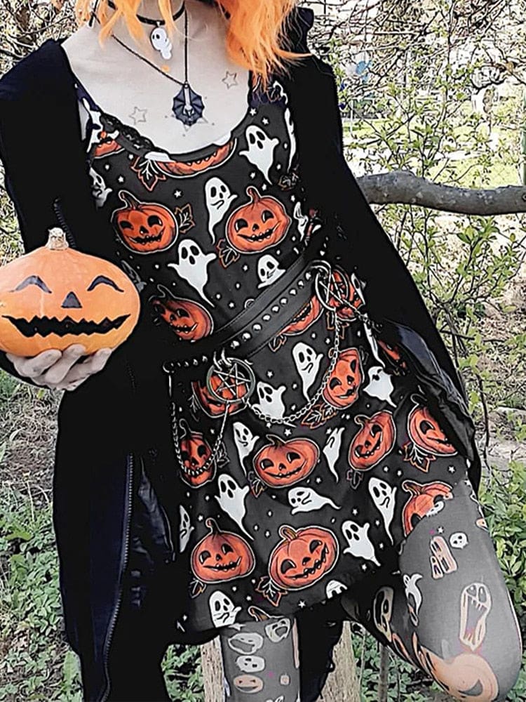 An orange-haired model wears the black spaghetti-strap pumpkin dress outdoors while holding a pumpkin, with white ghosts scattered among orange jack-o-lanterns.