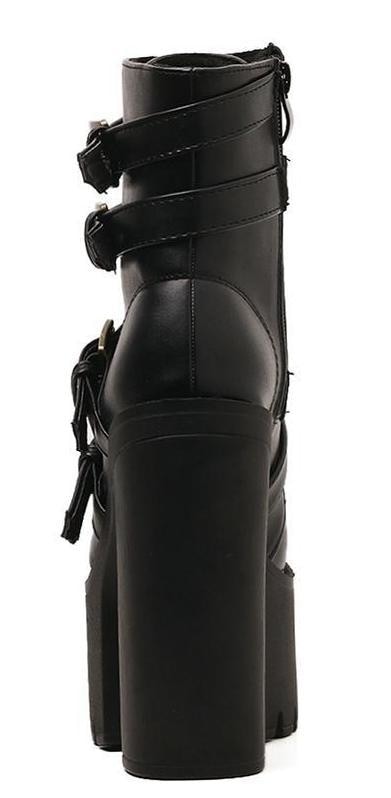 Rear view of a black ankle boot highlighting the tall heel, back seam and wrapping buckle straps.