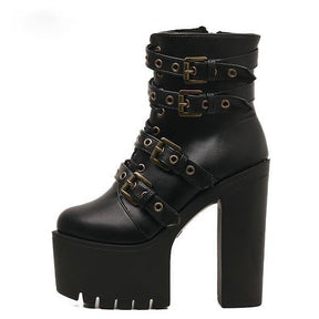 Side view of a black ankle boot showing four buckle straps, a thick front platform and a separate chunky heel.