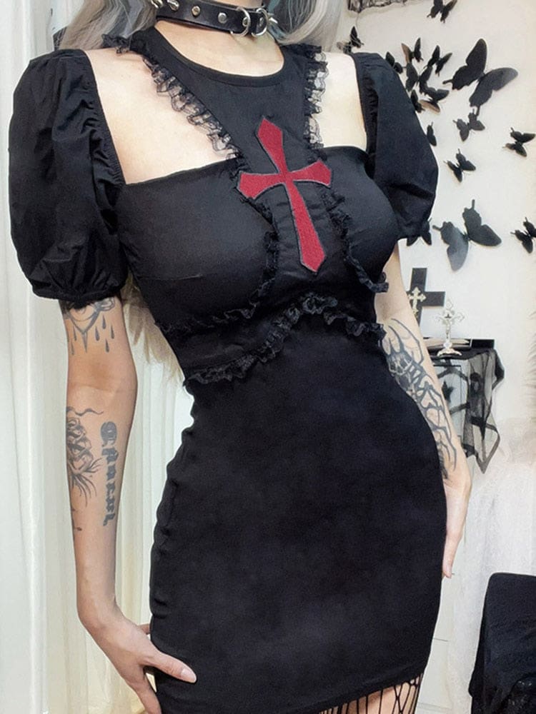 Angled outfit view of the black red-cross mini dress, highlighting the raised puff sleeve and lace-trimmed seams curving below the bust.