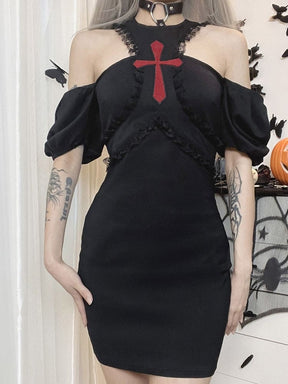 Straight-on view of the black Chapel dress worn off the shoulders, with a red cross centred between the open upper-chest sections.