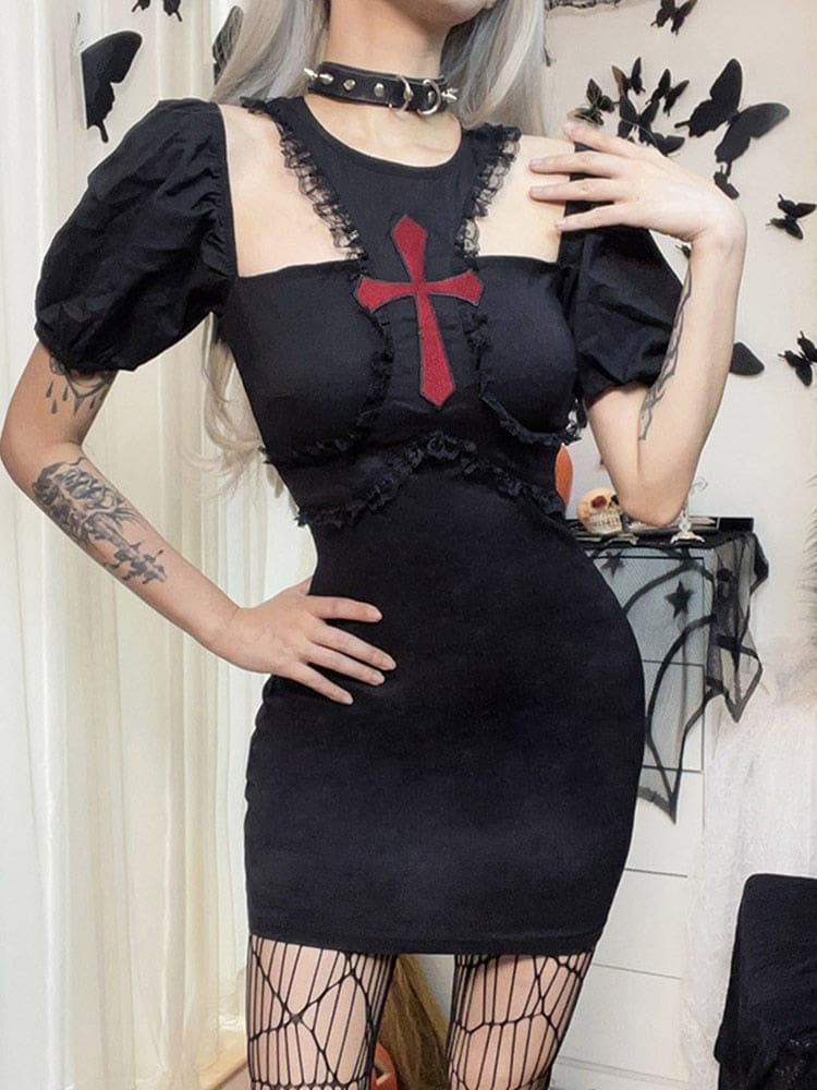 Front outfit view of the fitted black Chapel mini dress with a red cross, upper-chest cutouts and raised puff sleeves, styled with a black choker and patterned stockings.