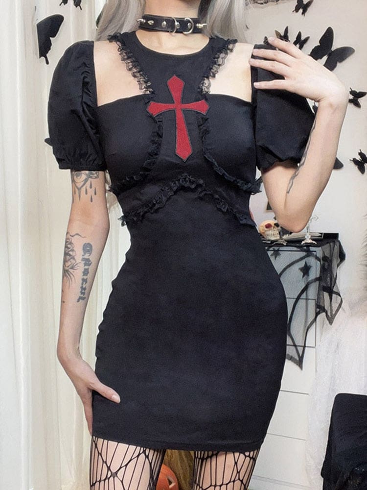 Closer front view of the black Chapel dress with a hand lifted near the lace-edged chest cutout and gathered puff sleeve.